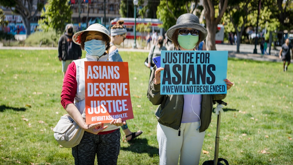 a couple of people holding signs