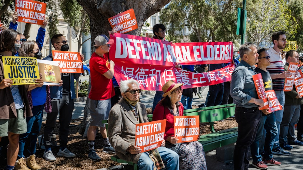 a group of people holding signs