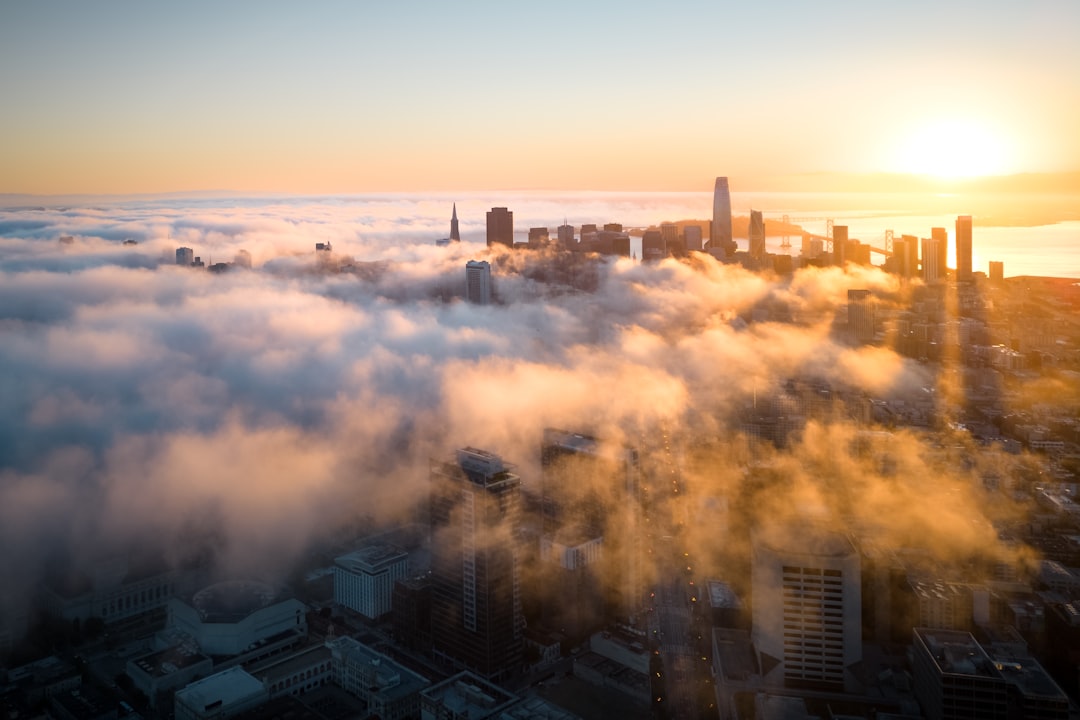 a city with many buildings and a sunset,