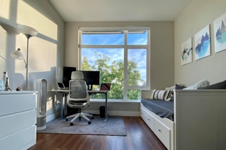 a bedroom with a desk and a chair