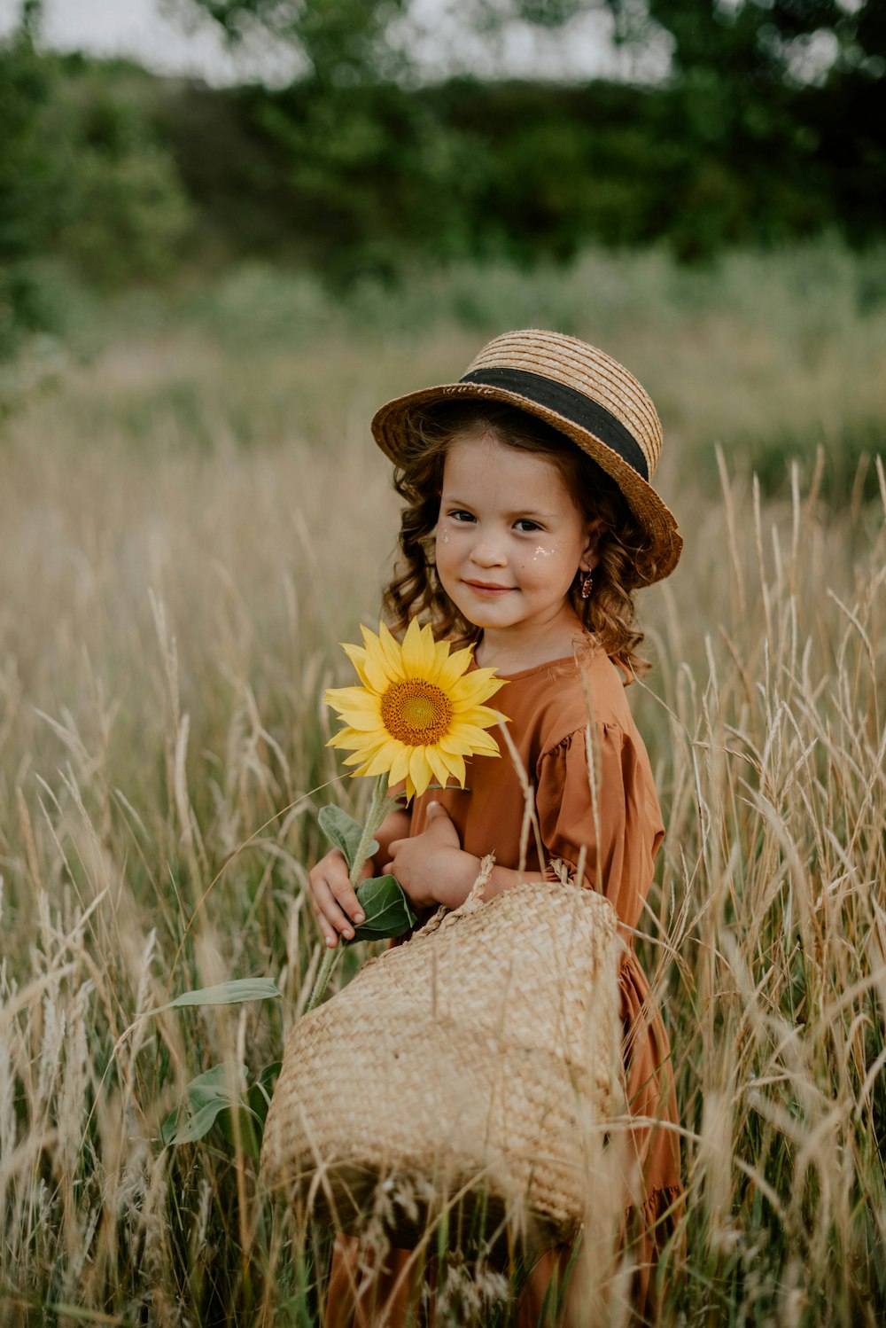 a girl holding a yellow flower