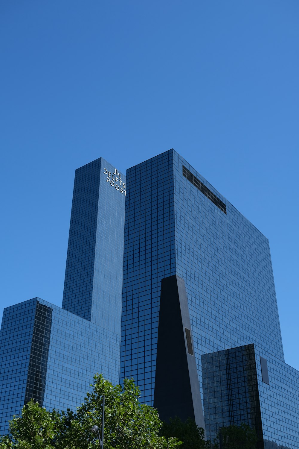 a couple of skyscrapers with Fountain Place in the background