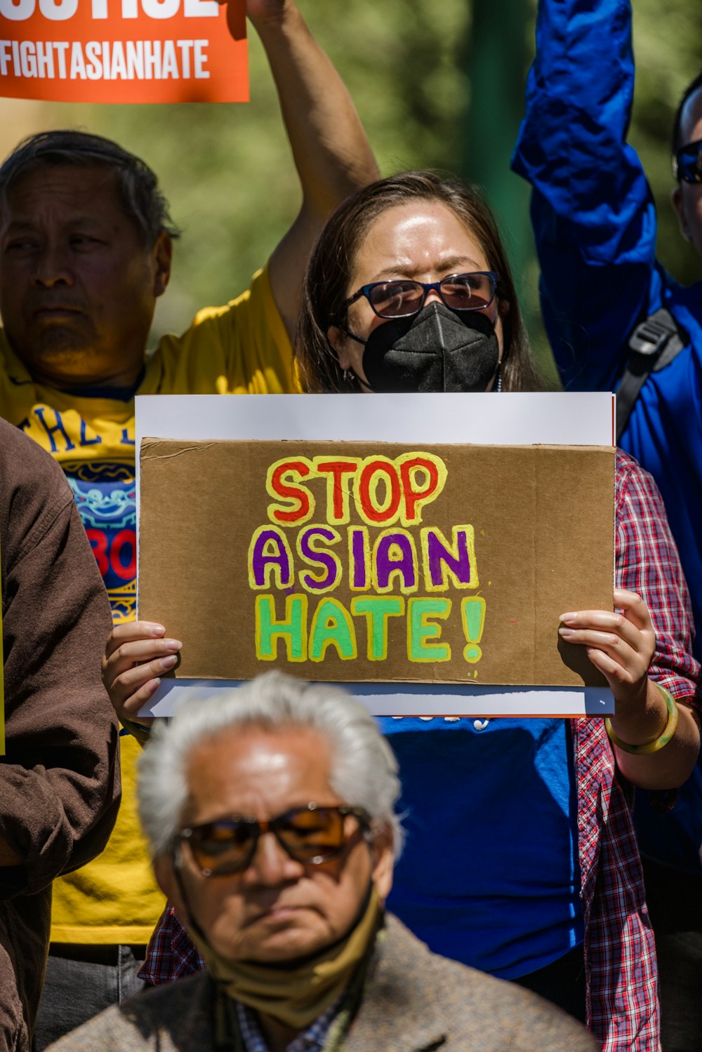 a group of people holding a sign