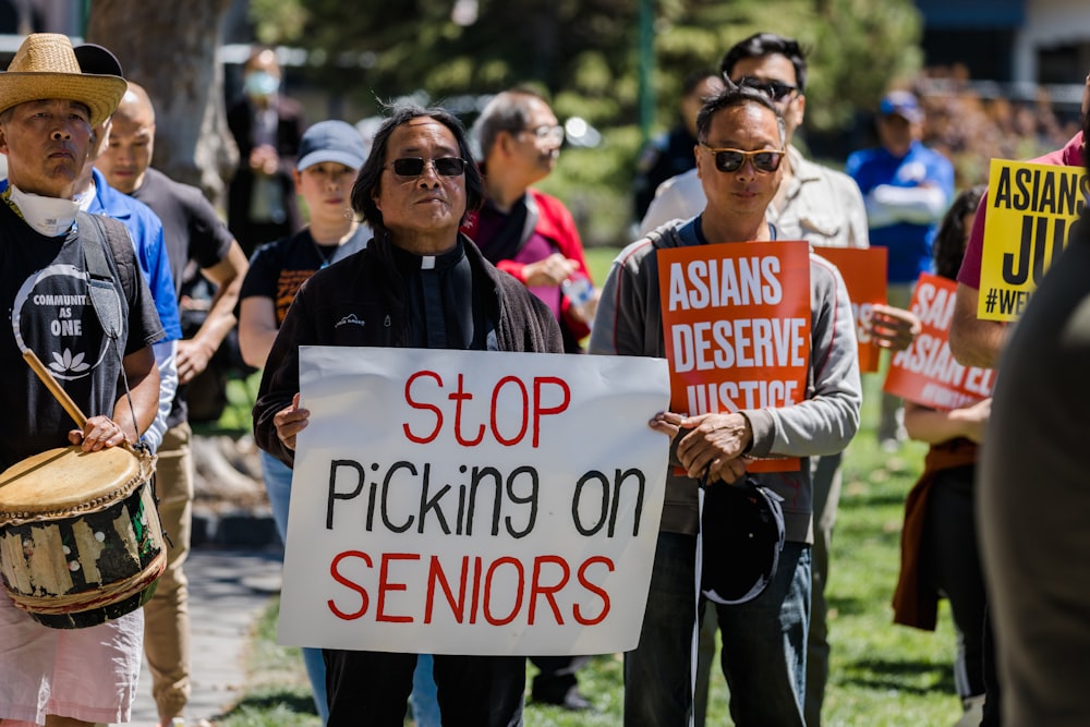 a group of people holding signs