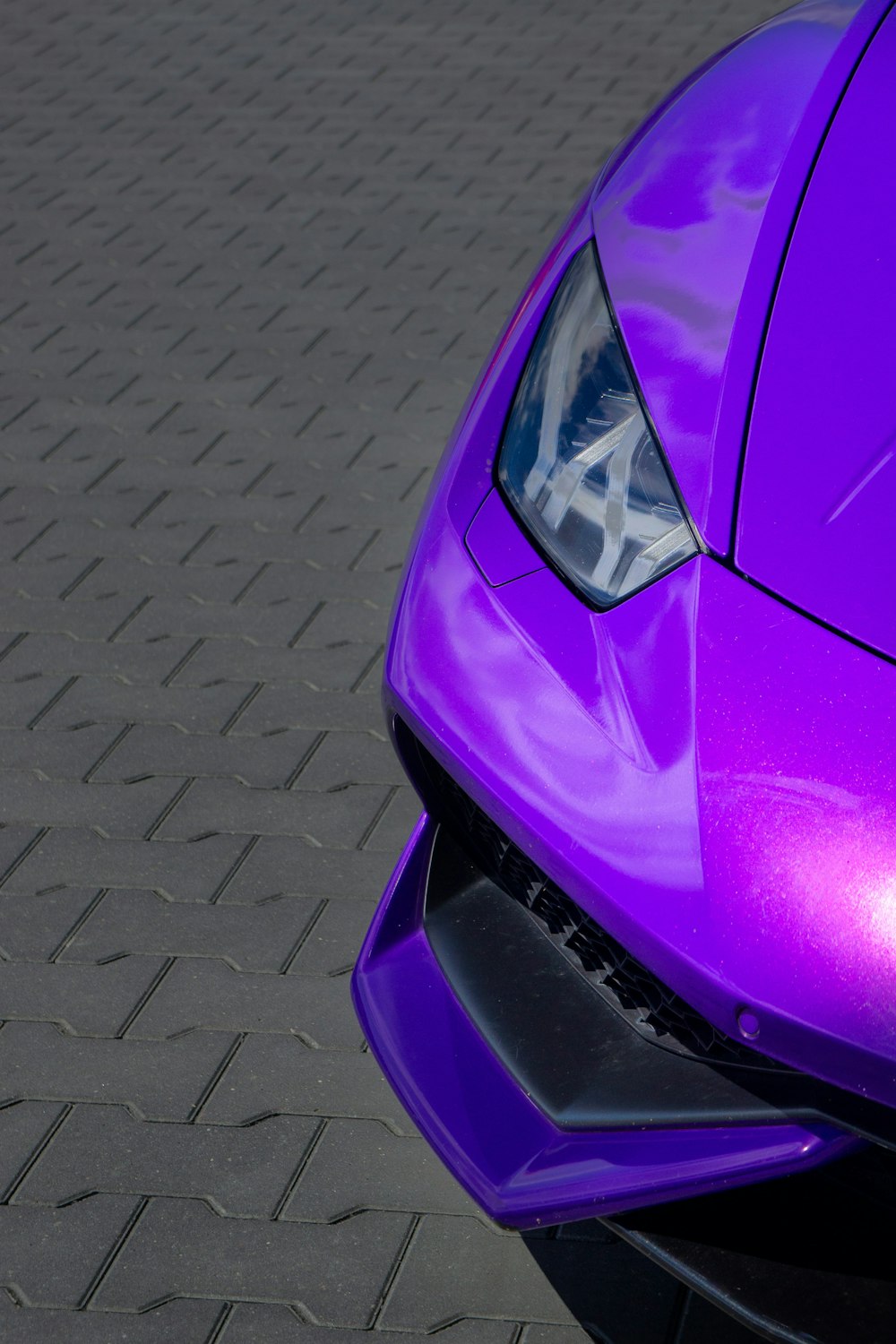 a purple car with a reflection of a person in it