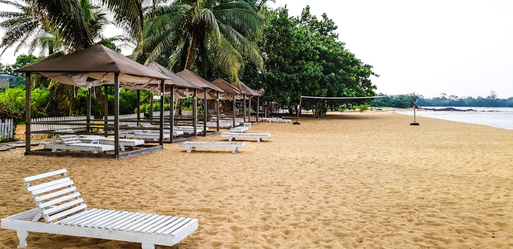 a beach with umbrellas and chairs