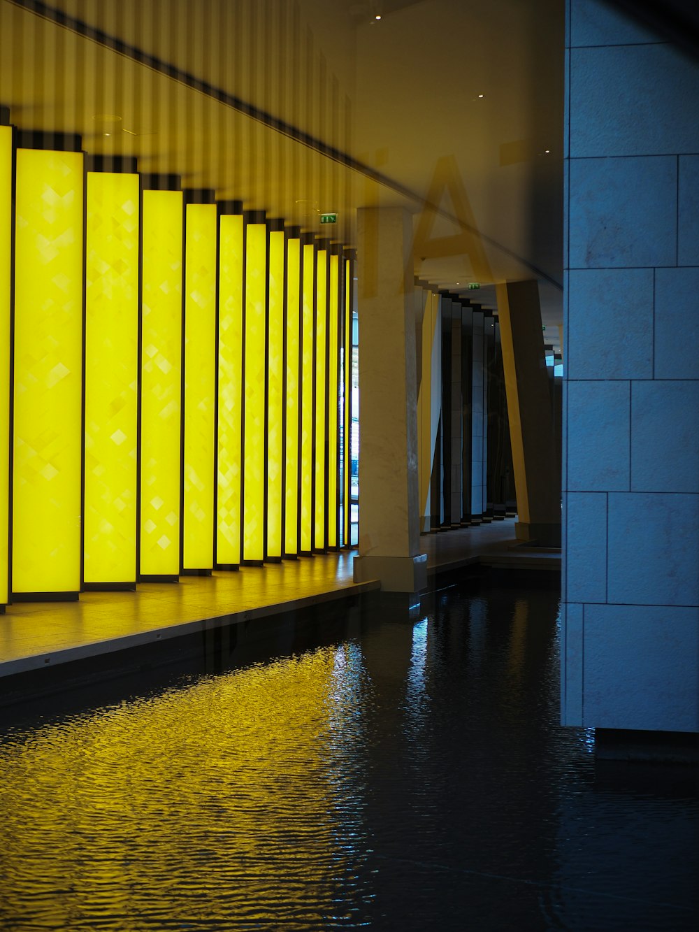 a hallway with yellow and blue tile