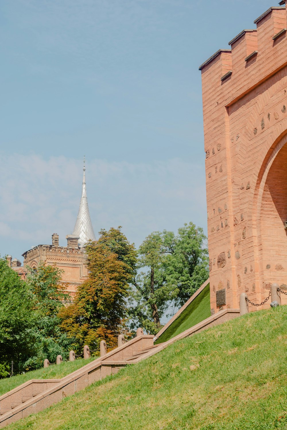 a large brick tower with a clock on the side of a building