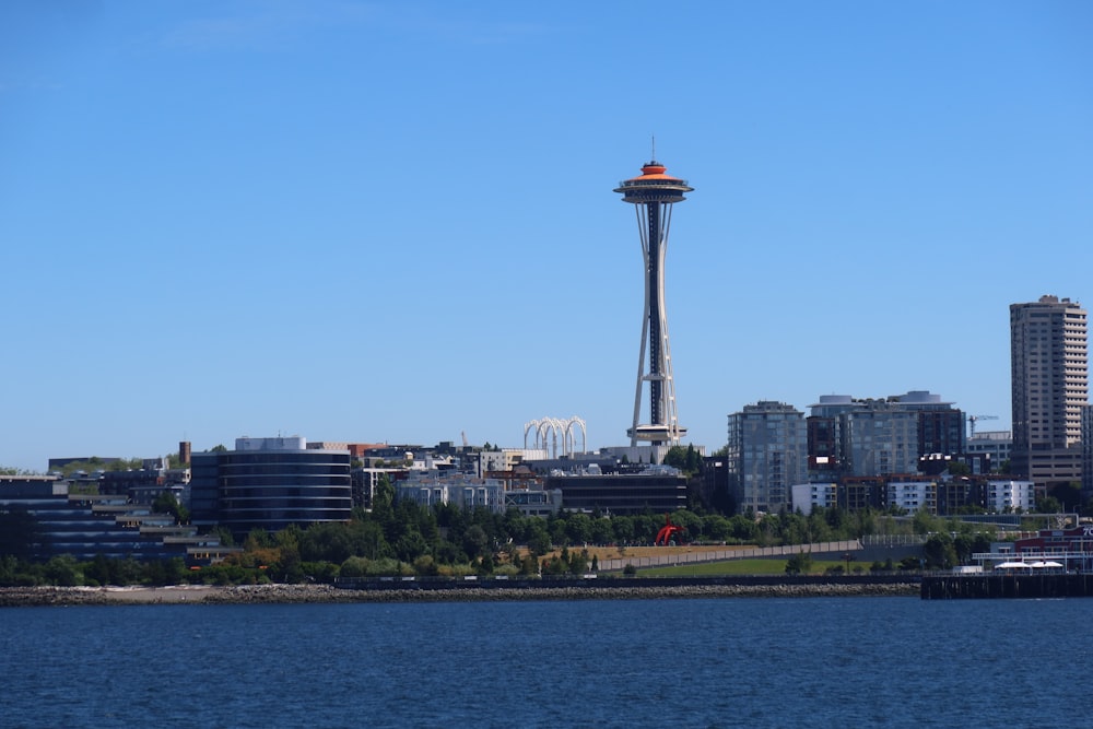 a city skyline with a tall tower