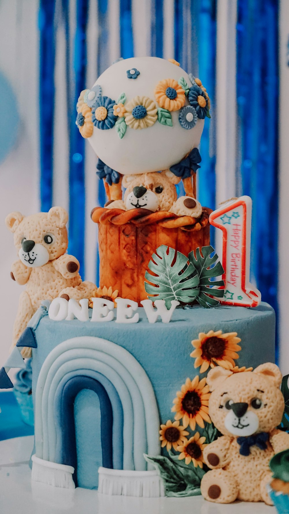 a cake with a bear and flowers