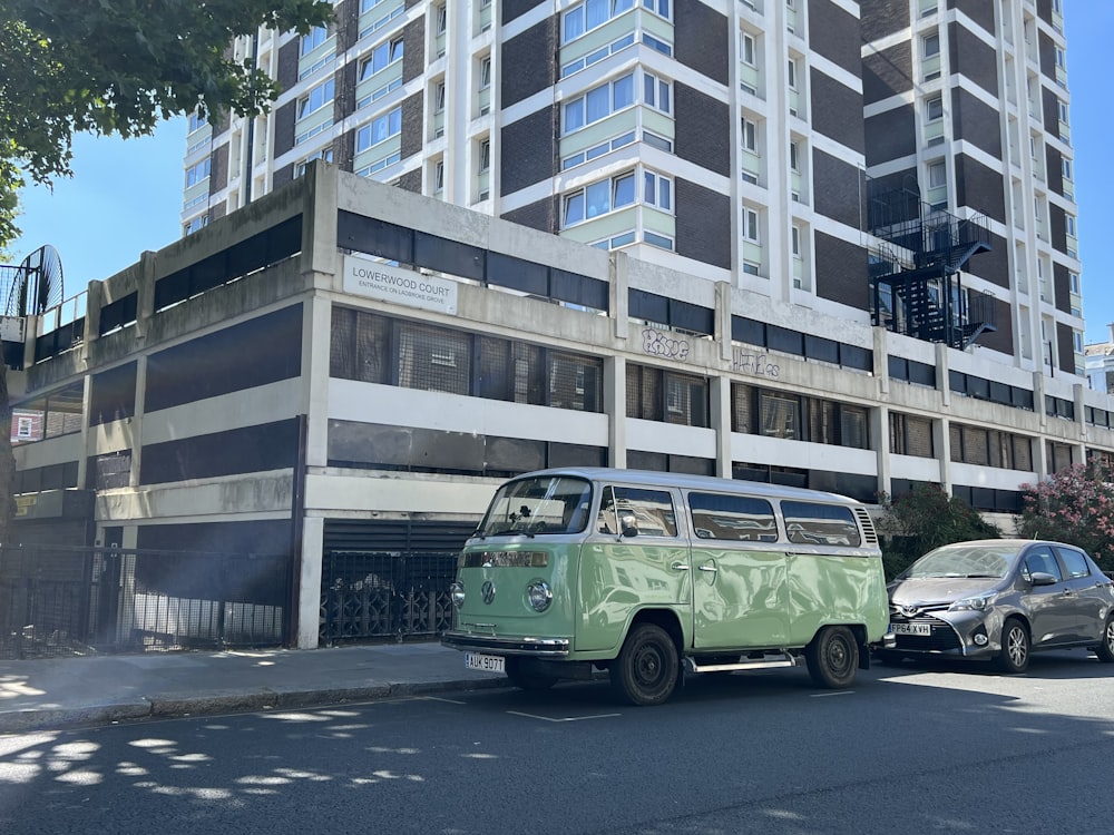 a green van parked in front of a building