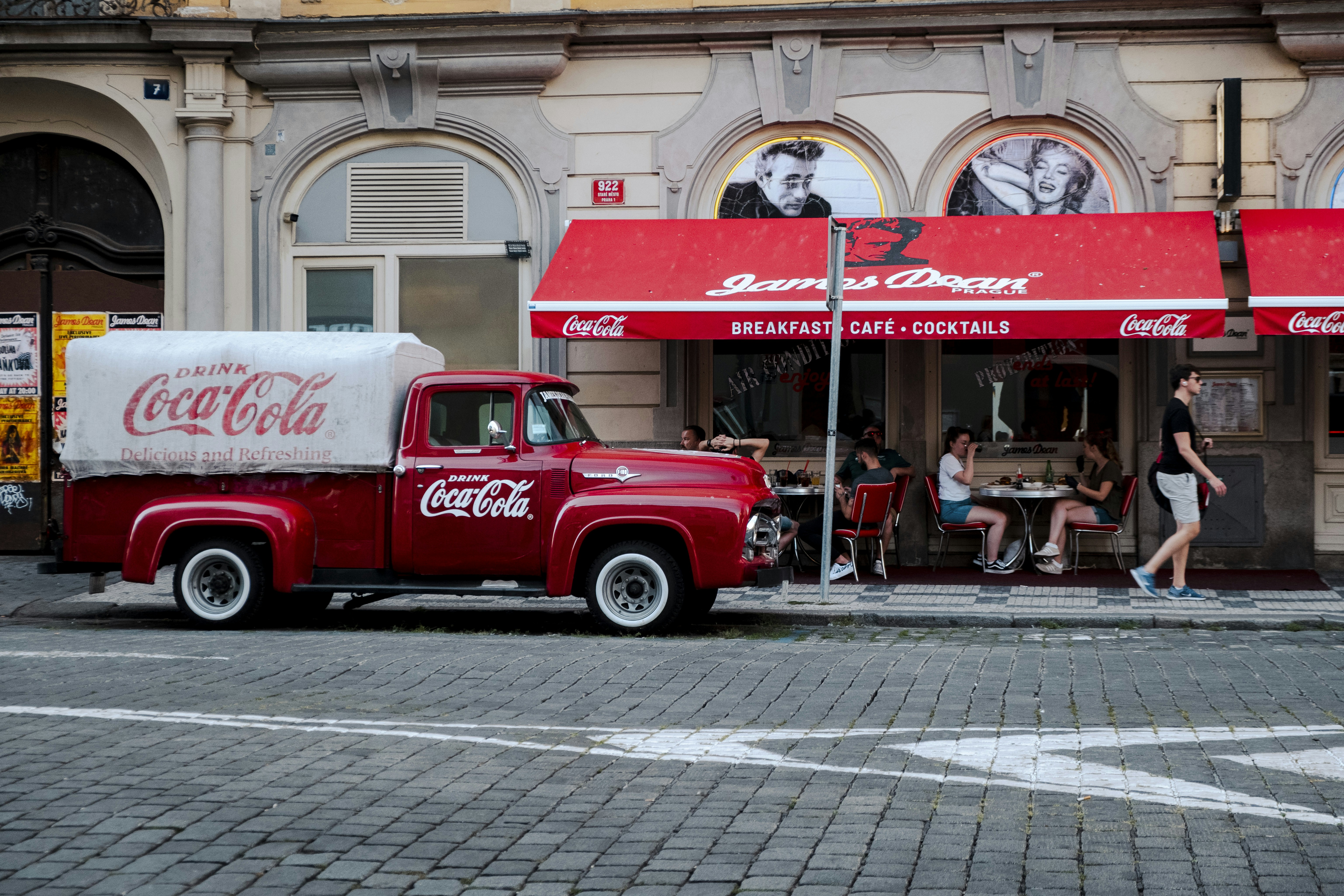 a red truck parked in front of a restaurant