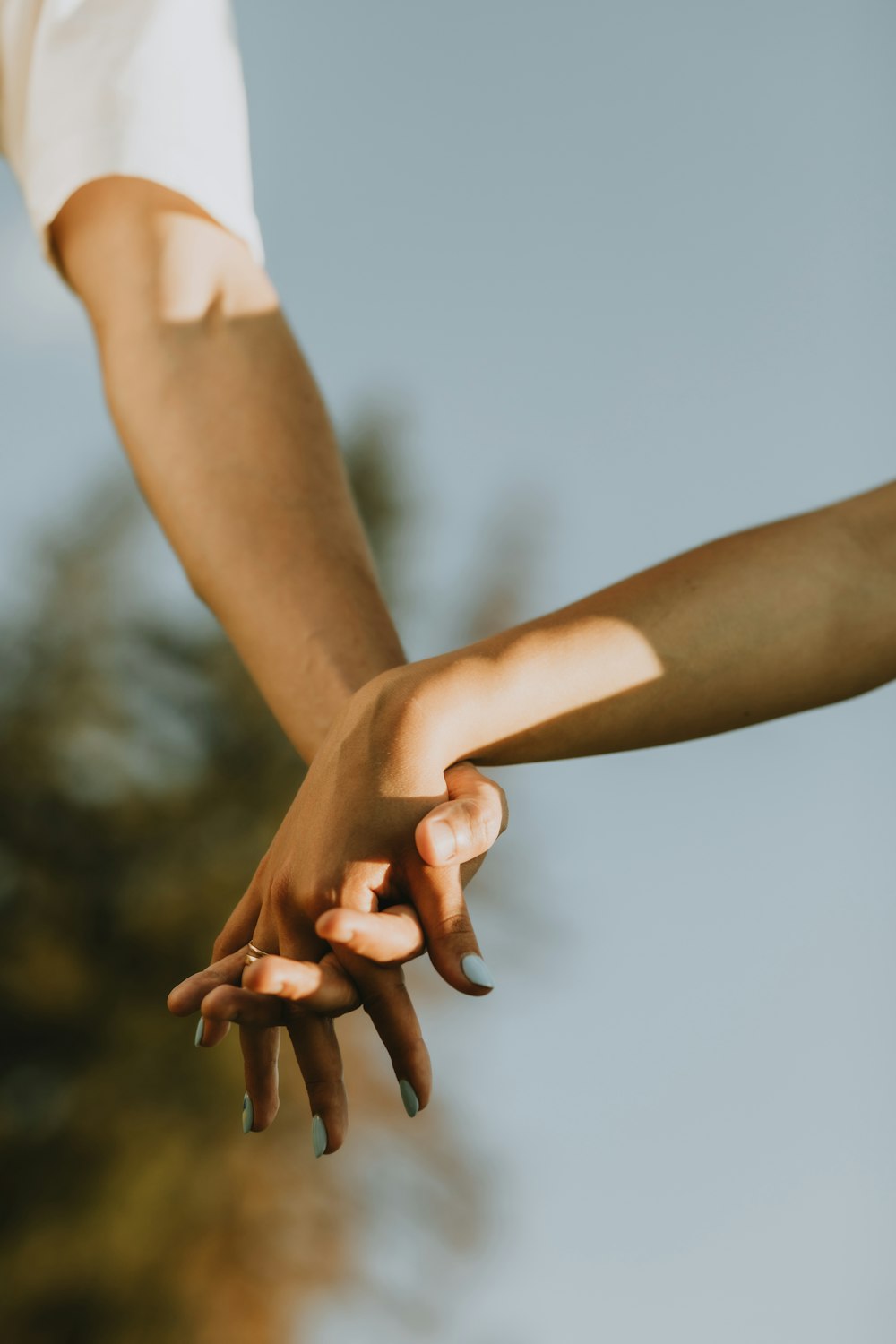 a close-up of a man and a woman holding hands