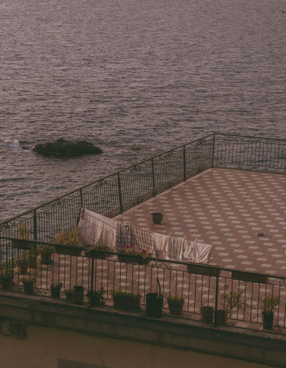 a roof with a view of the ocean and a small island