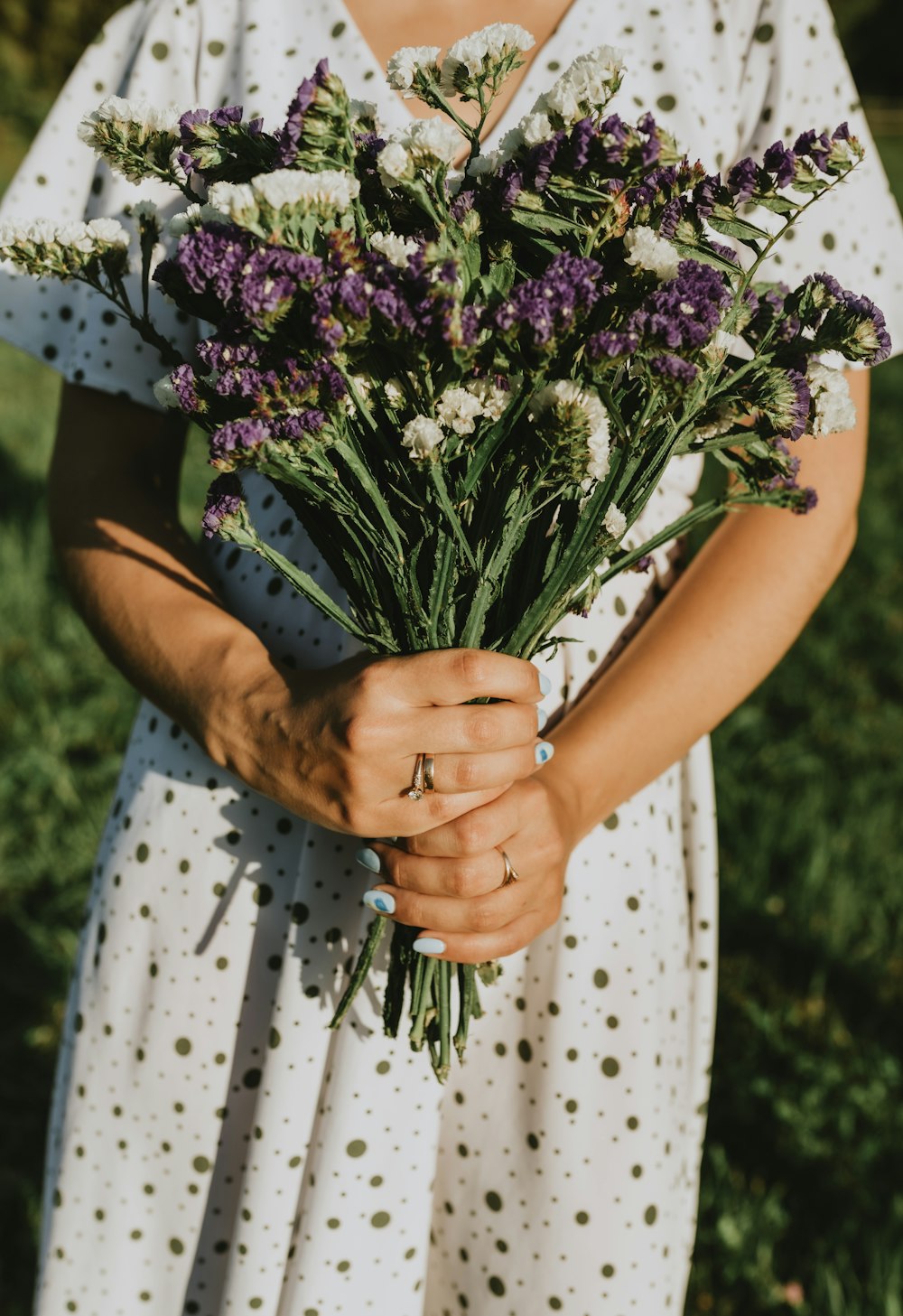 a woman holding a bouquet of flowers