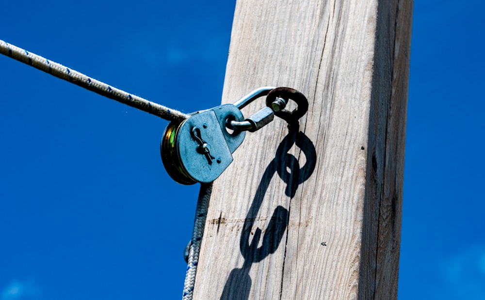 a metal door handle on a wooden post