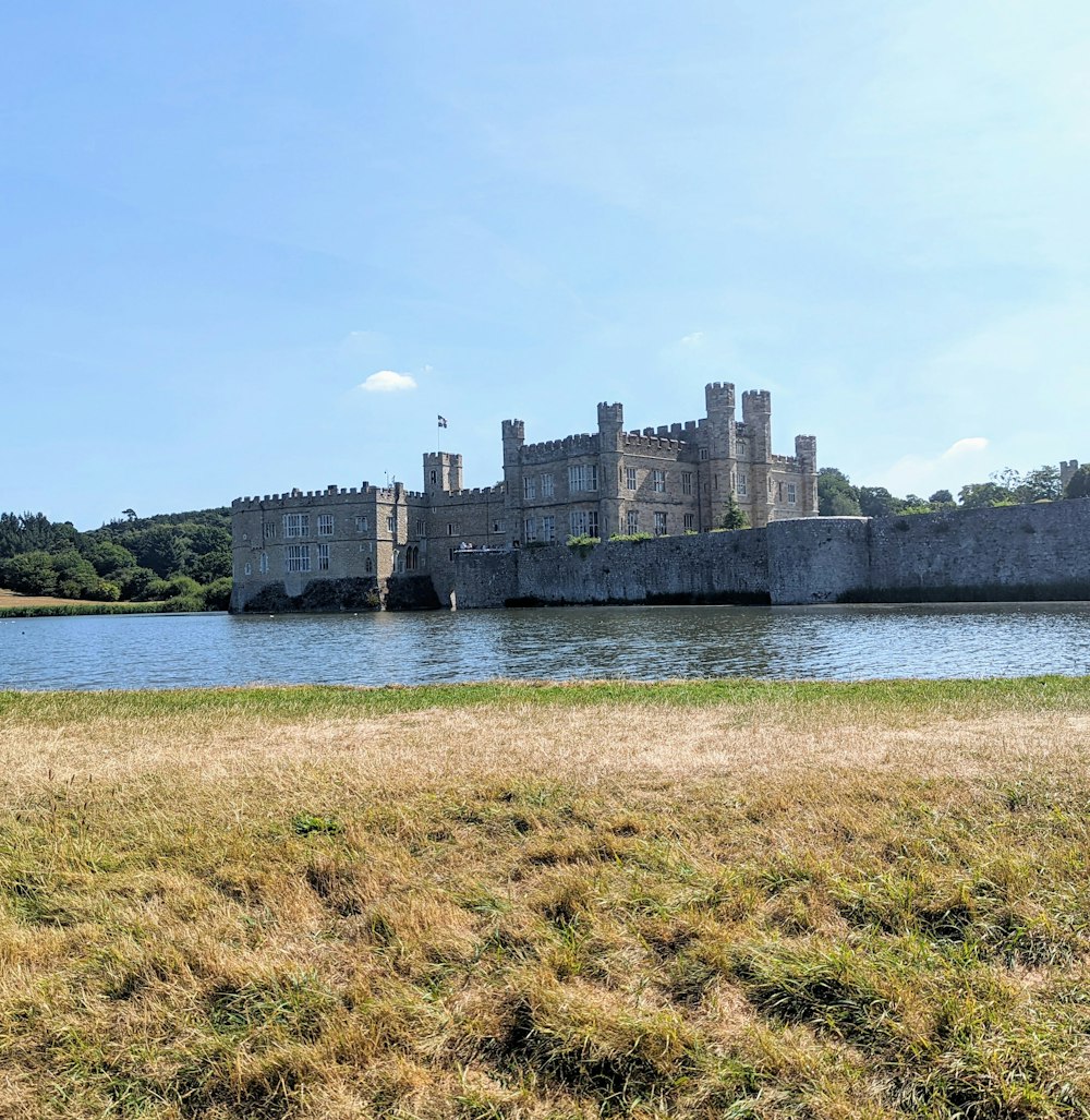 a castle on a hill by a river