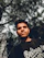A confident young Indian man smiling with a serene background symbolizing renewed focus and strength.