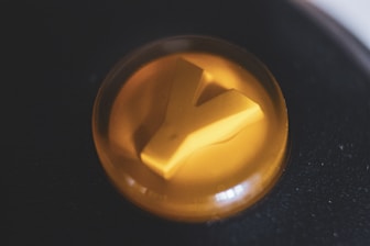 Close-up of a high-contrast button glowing on a black and antracite background