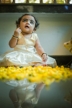 Soft natural light highlighting the intricate Munj decorations and baby attire.