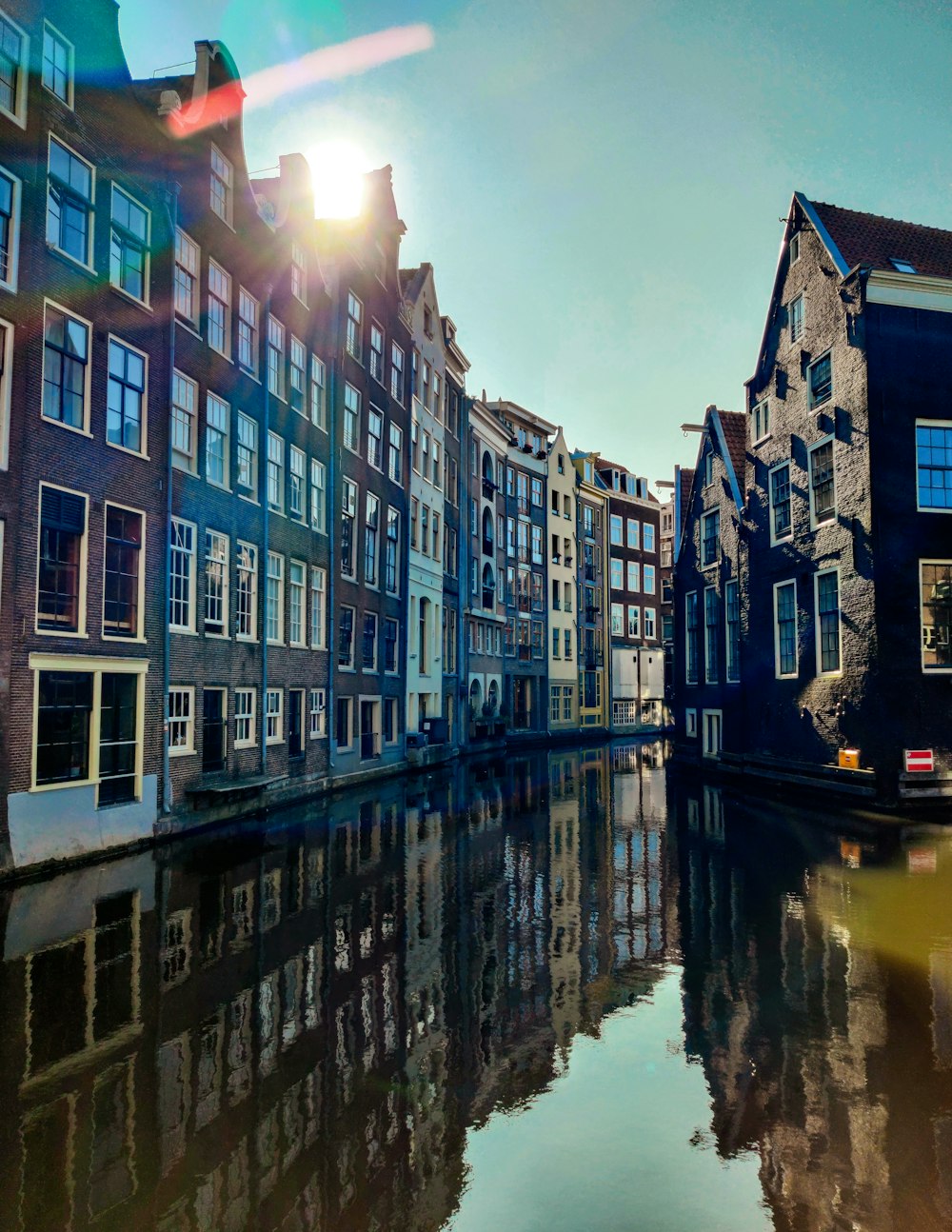 a row of buildings next to a body of water