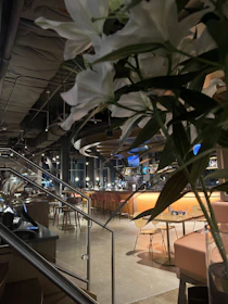 A stylish flower bar setup with guests selecting blooms against a backdrop of soft, ambient lighting.