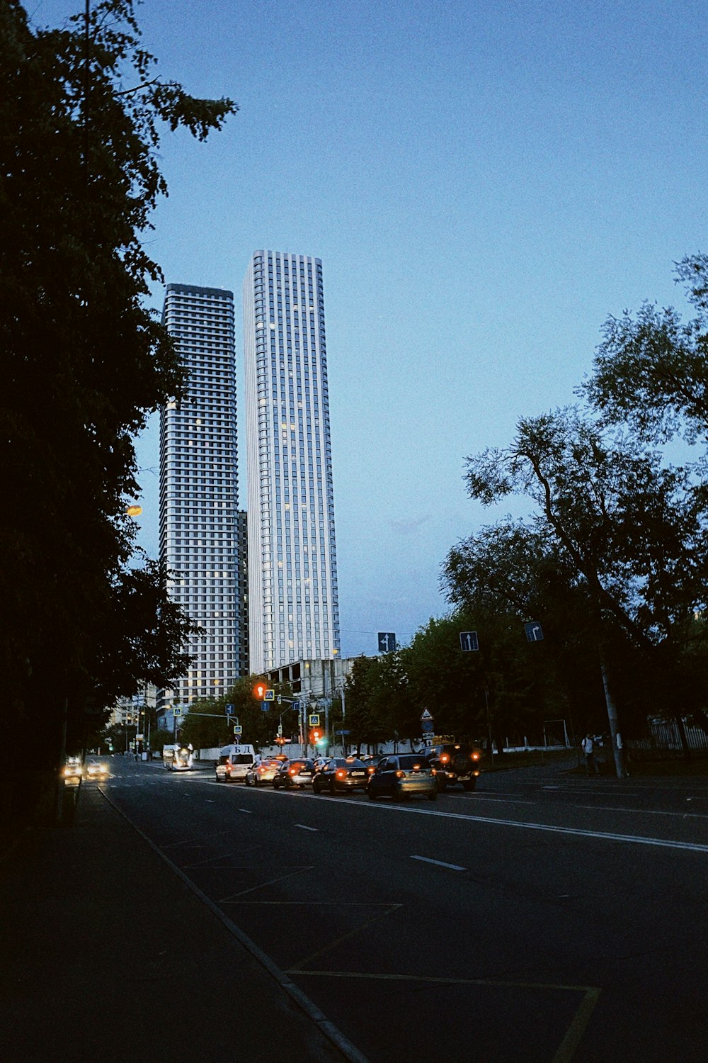 a street with cars and tall buildings