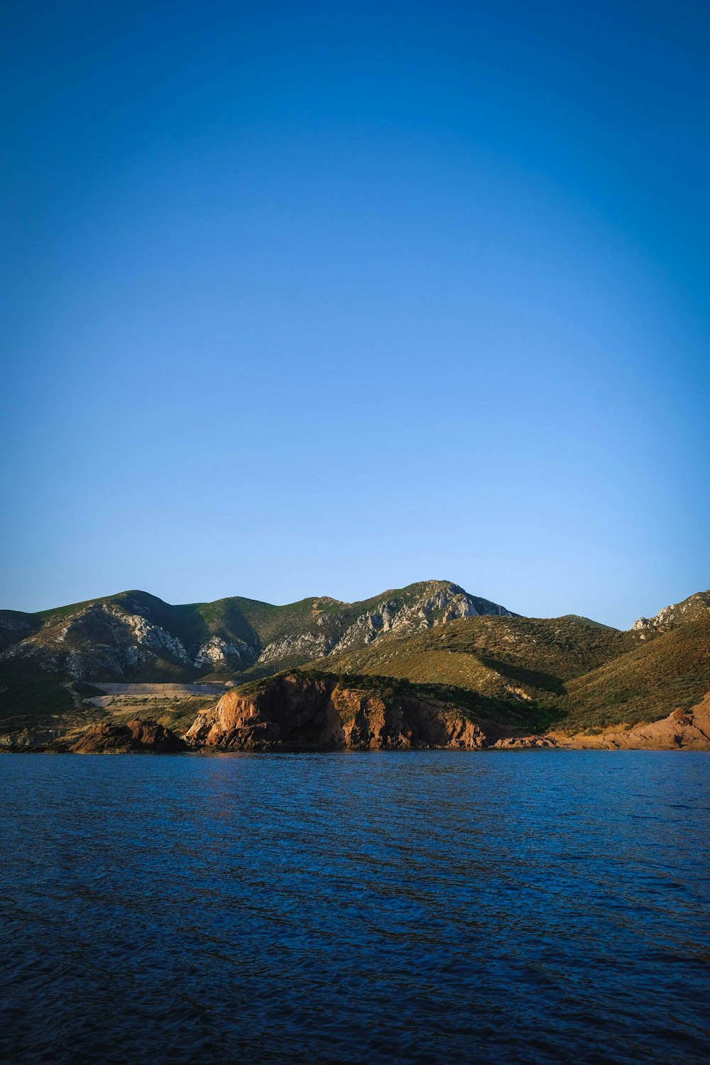 a body of water with hills in the background