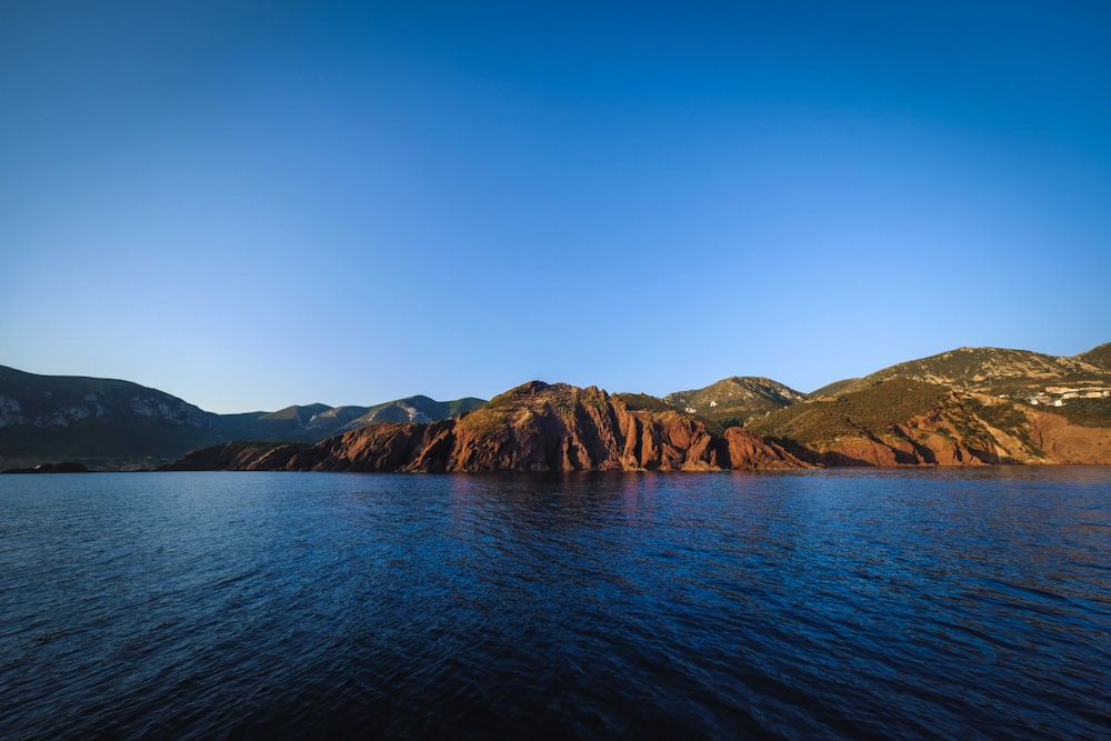 a body of water with a rocky shoreline