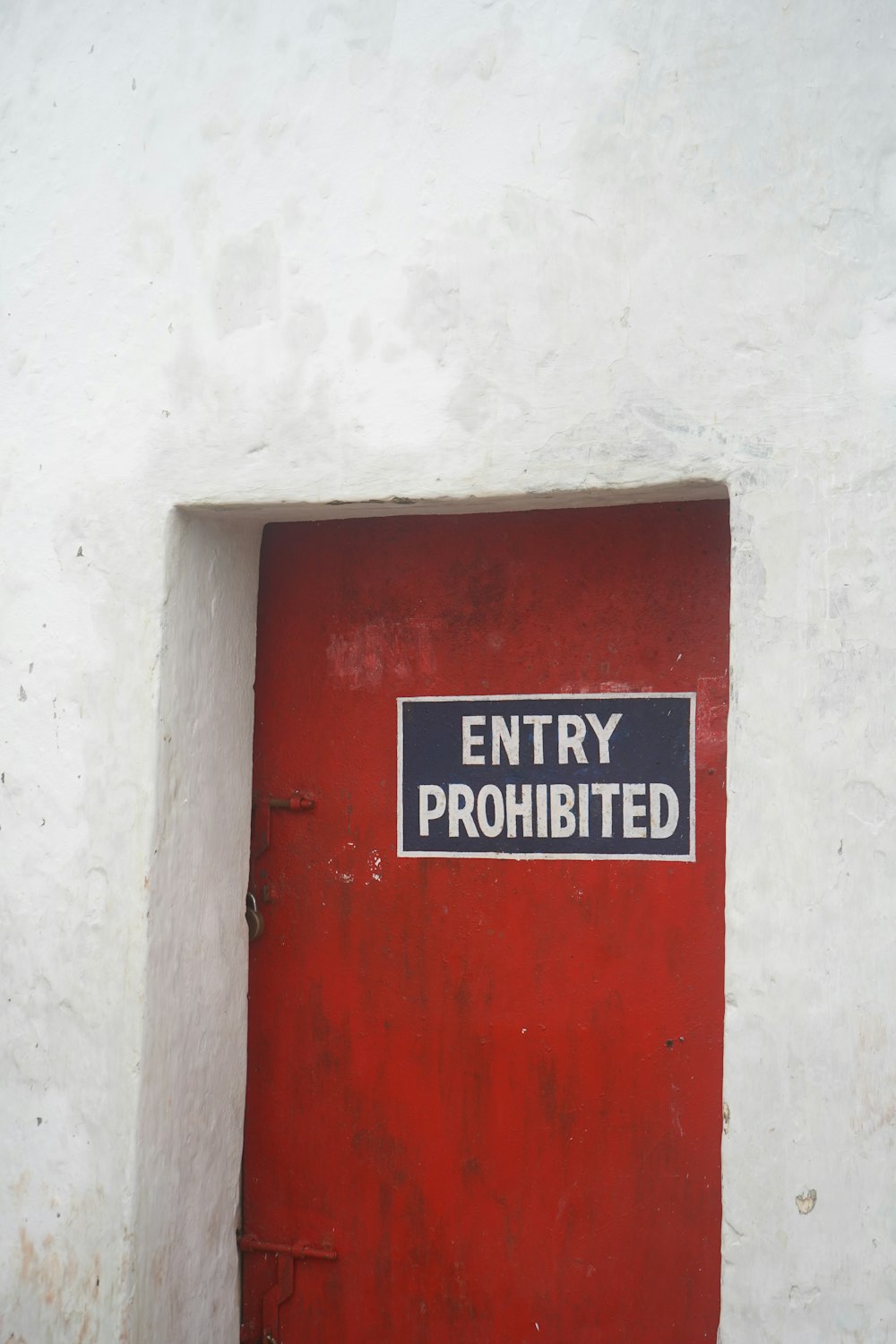 a red door with a sign on it