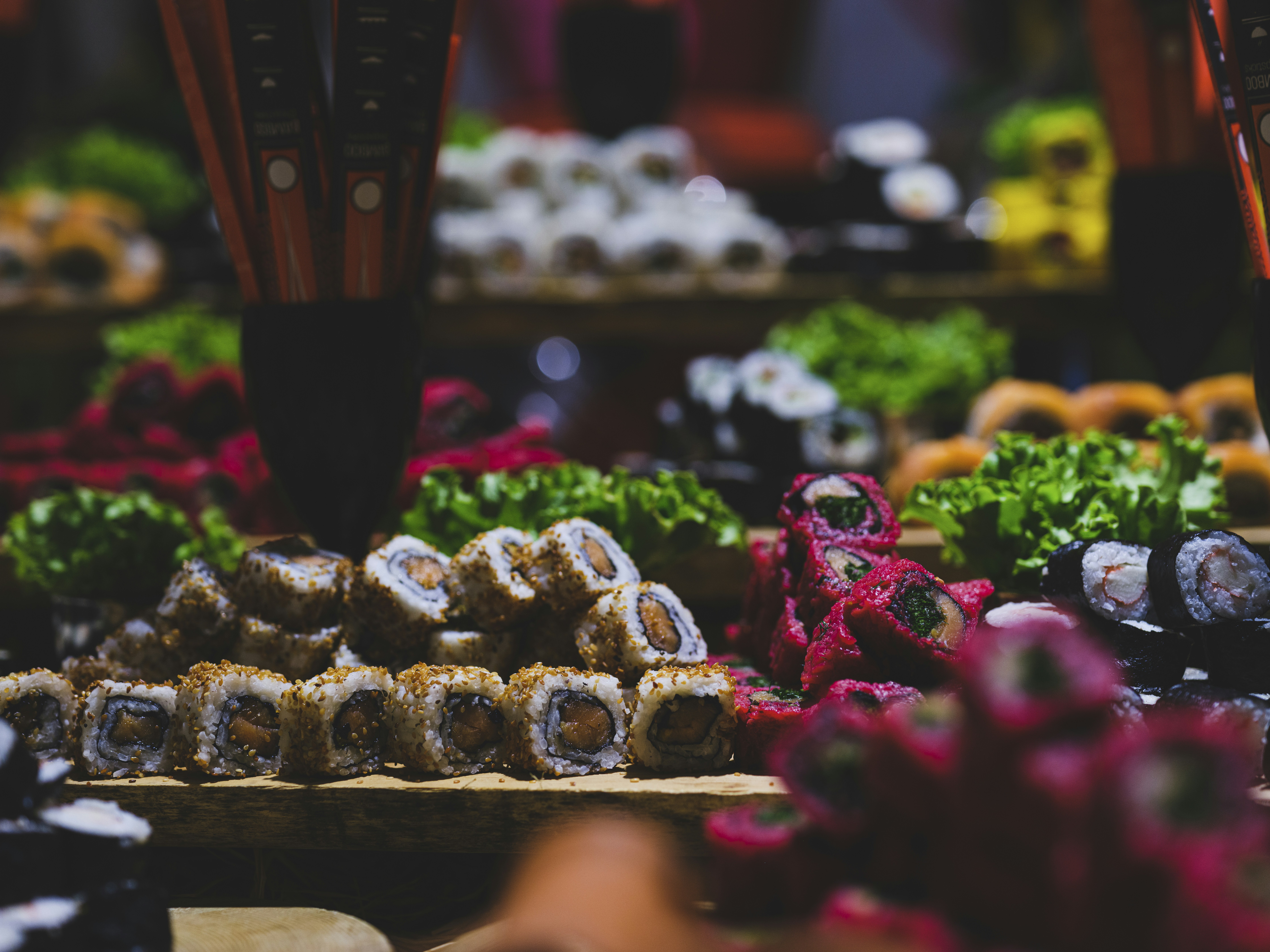 a display of chocolates, traditional Japanese sushi dishes at a hotel buffet