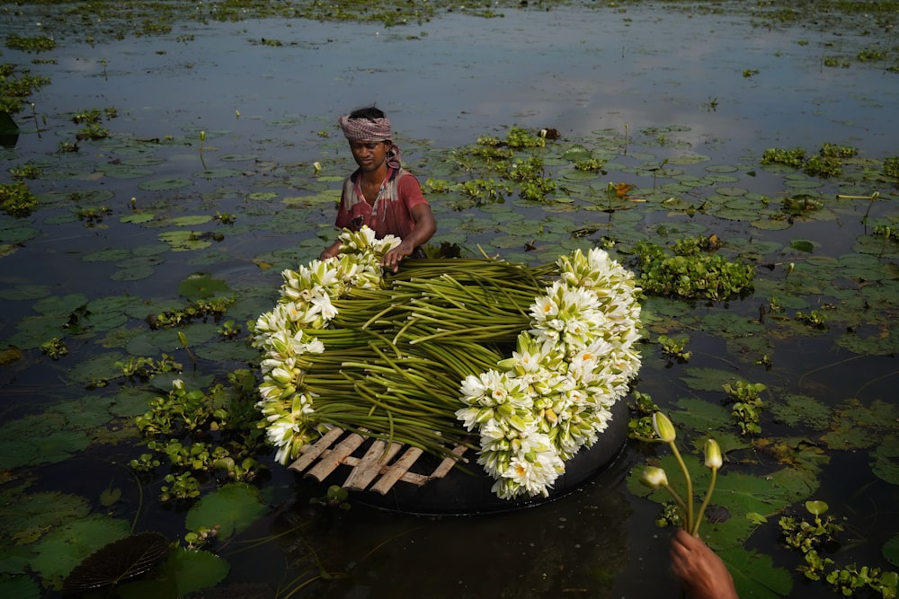 a person in a boat full of flowers