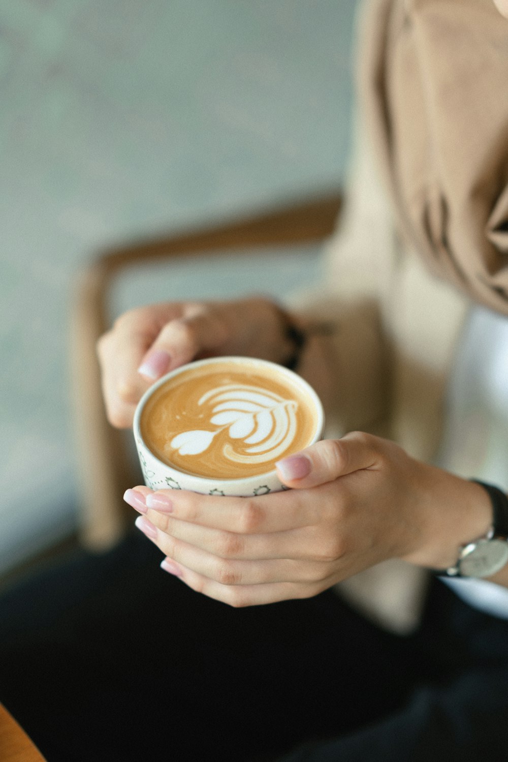 a person holding a cup of coffee