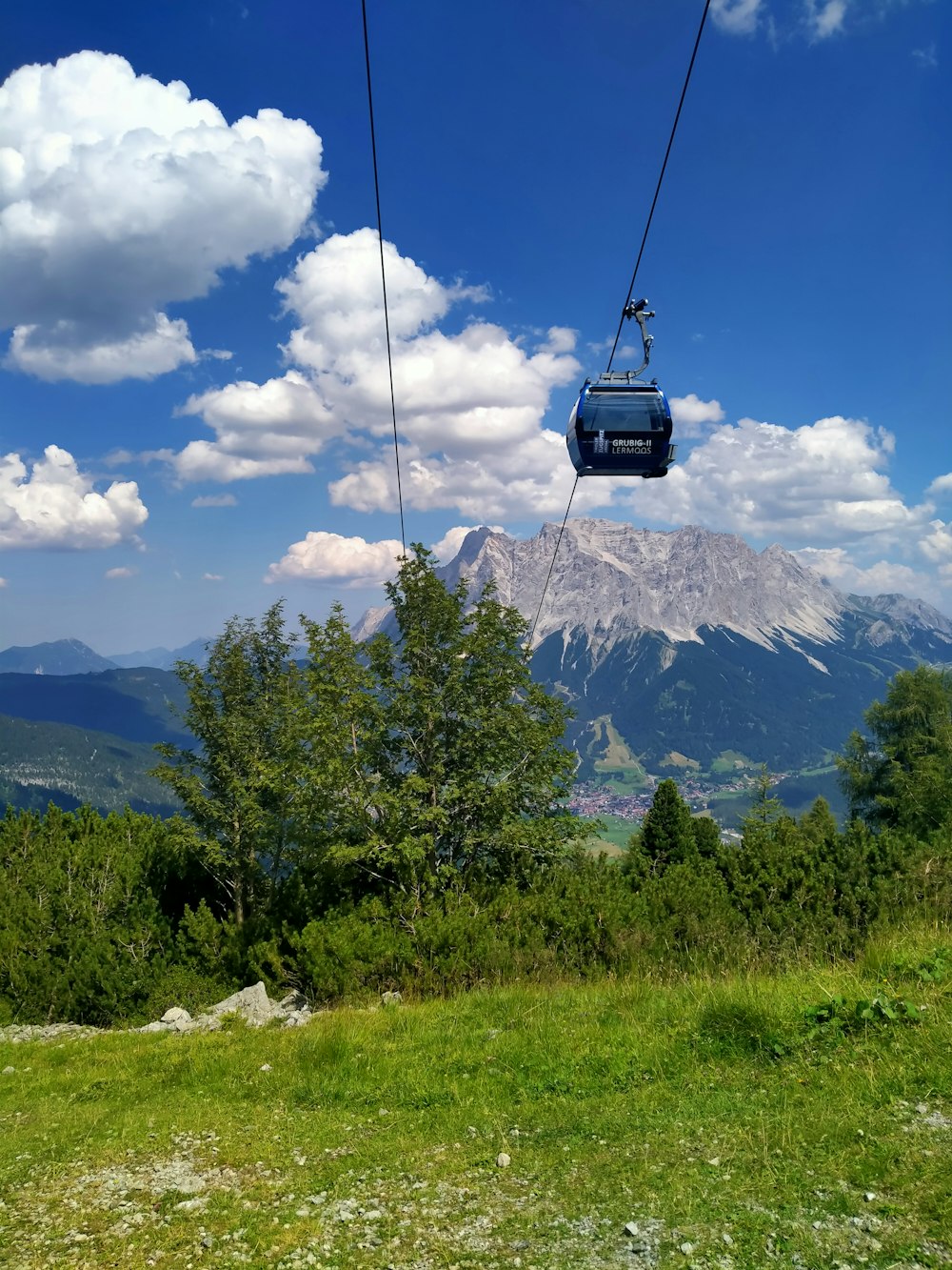 a cable car above a grassy hill