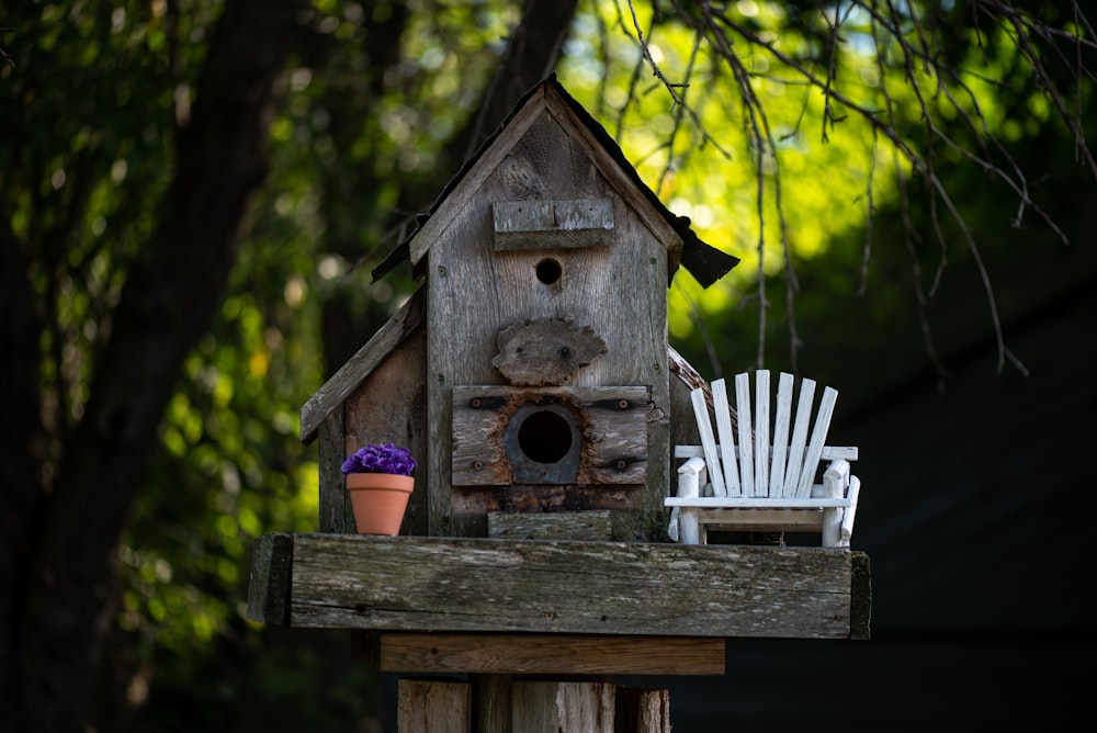 a birdhouse with a flower in it