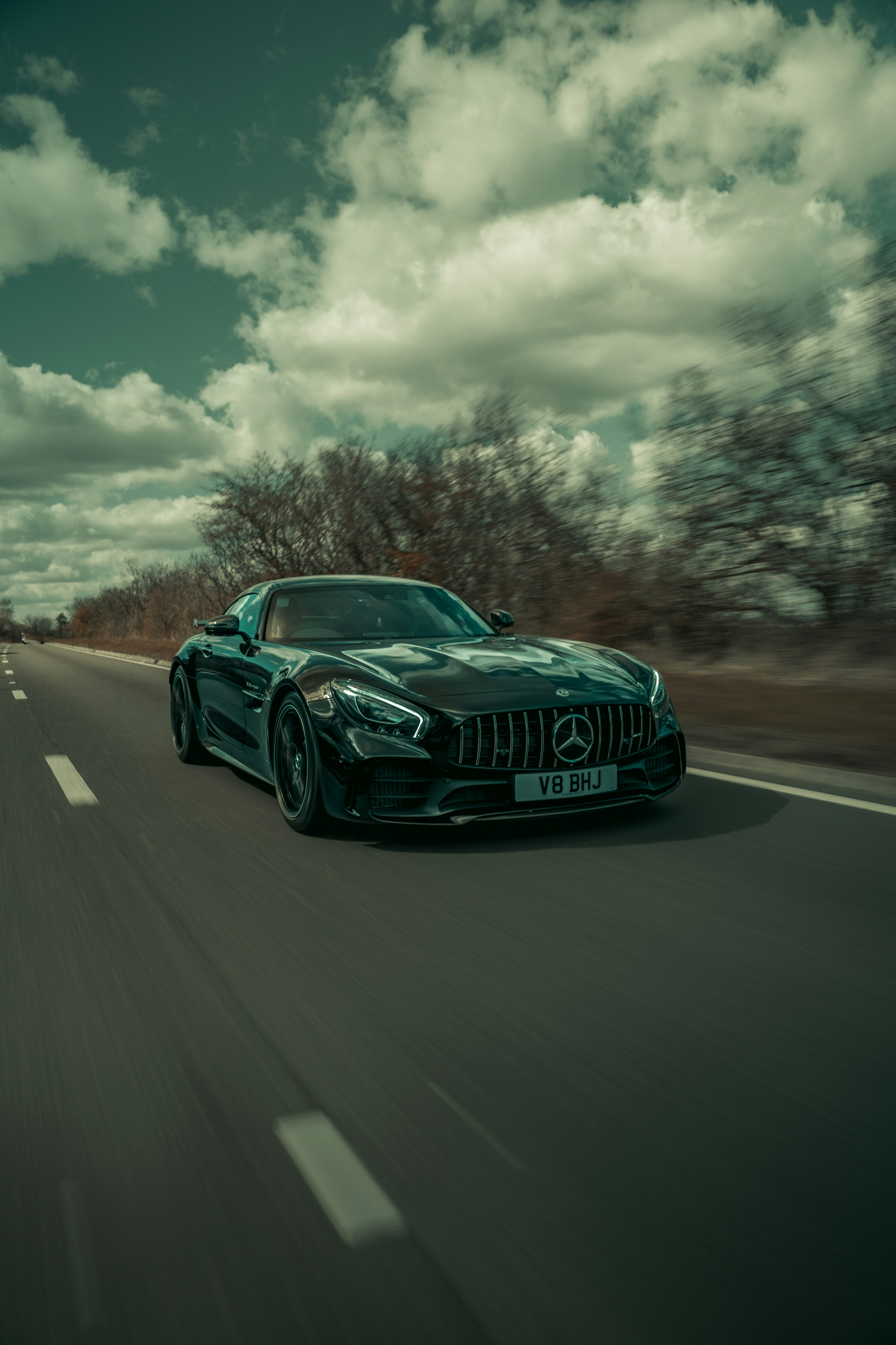 A black sports car driving down a road photo – Free London Image on ...