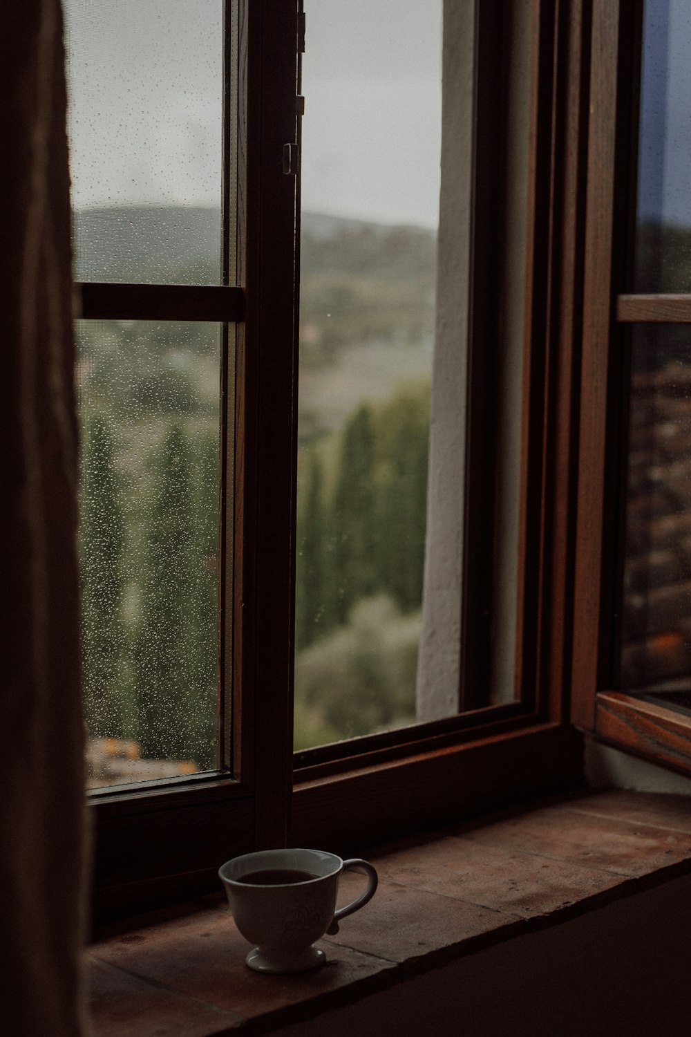 a cup of coffee on a windowsill