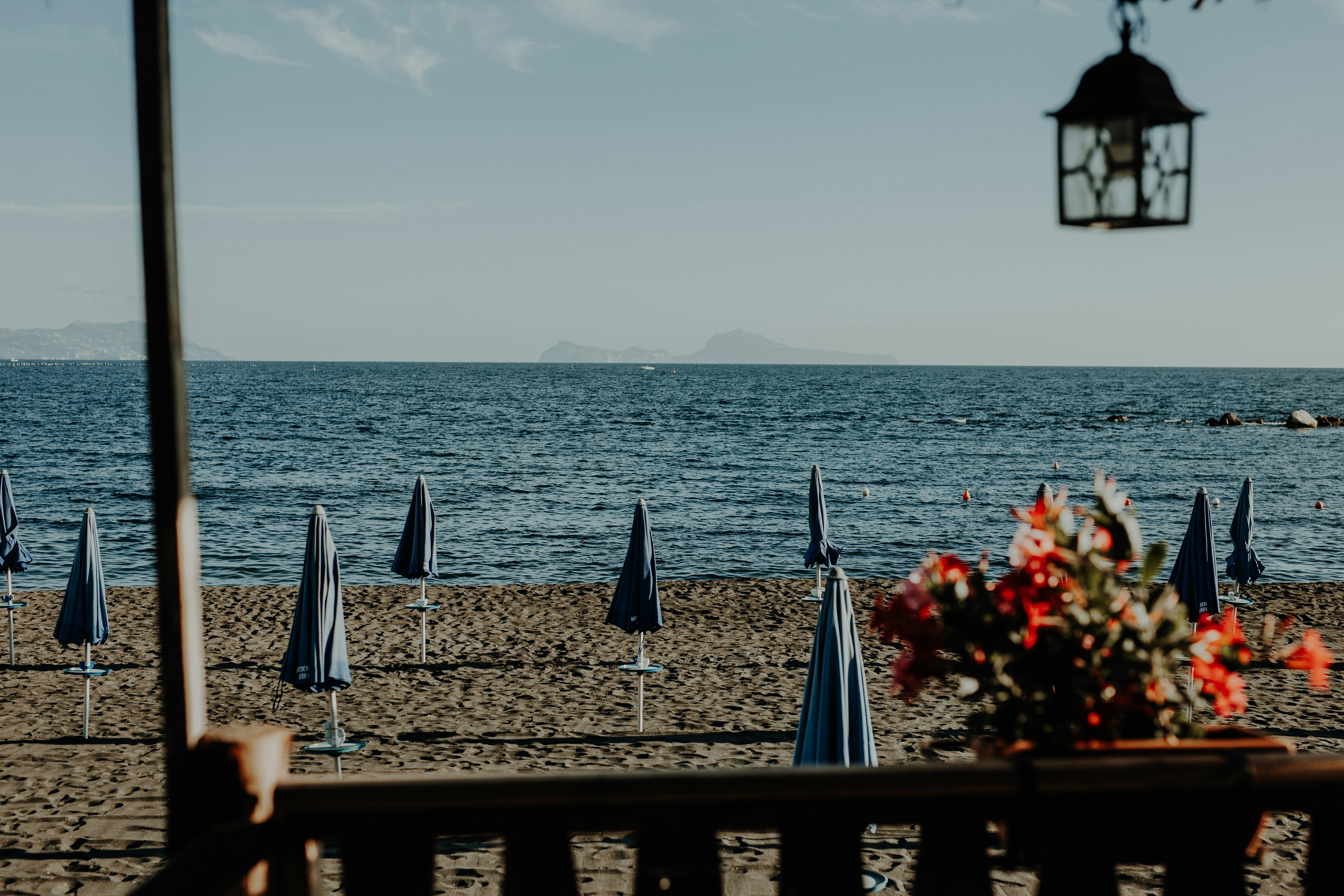 a beach with umbrellas and chairs