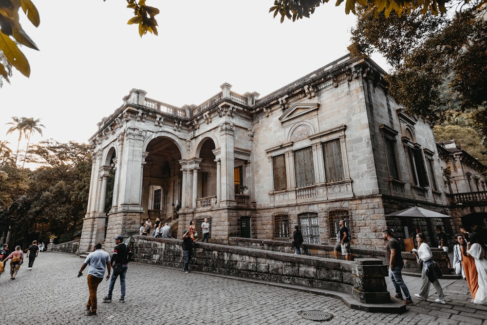 a group of people walking in front of a building