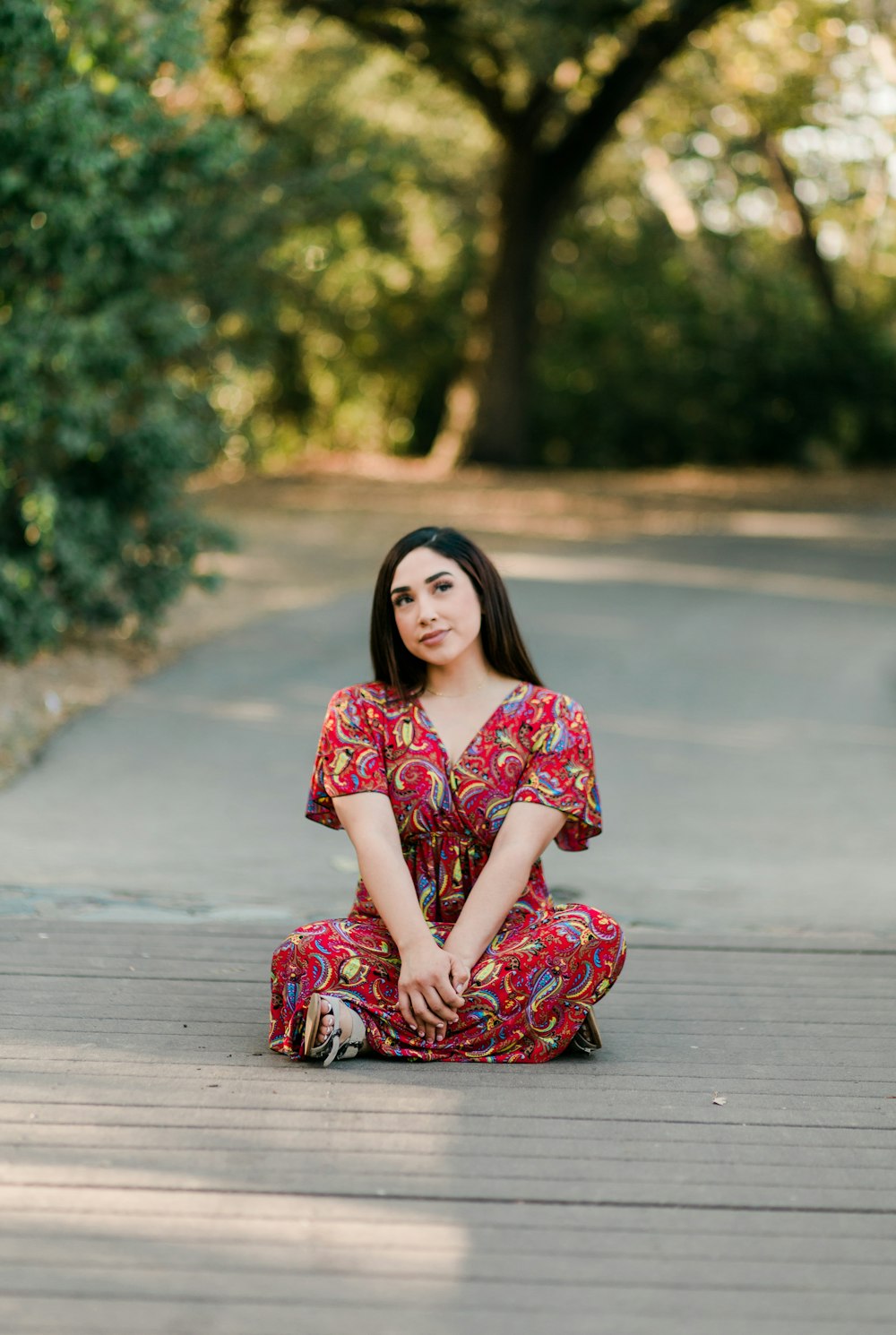 a woman sitting on a wood deck