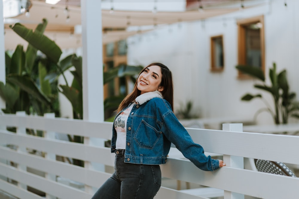 a woman leaning on a railing