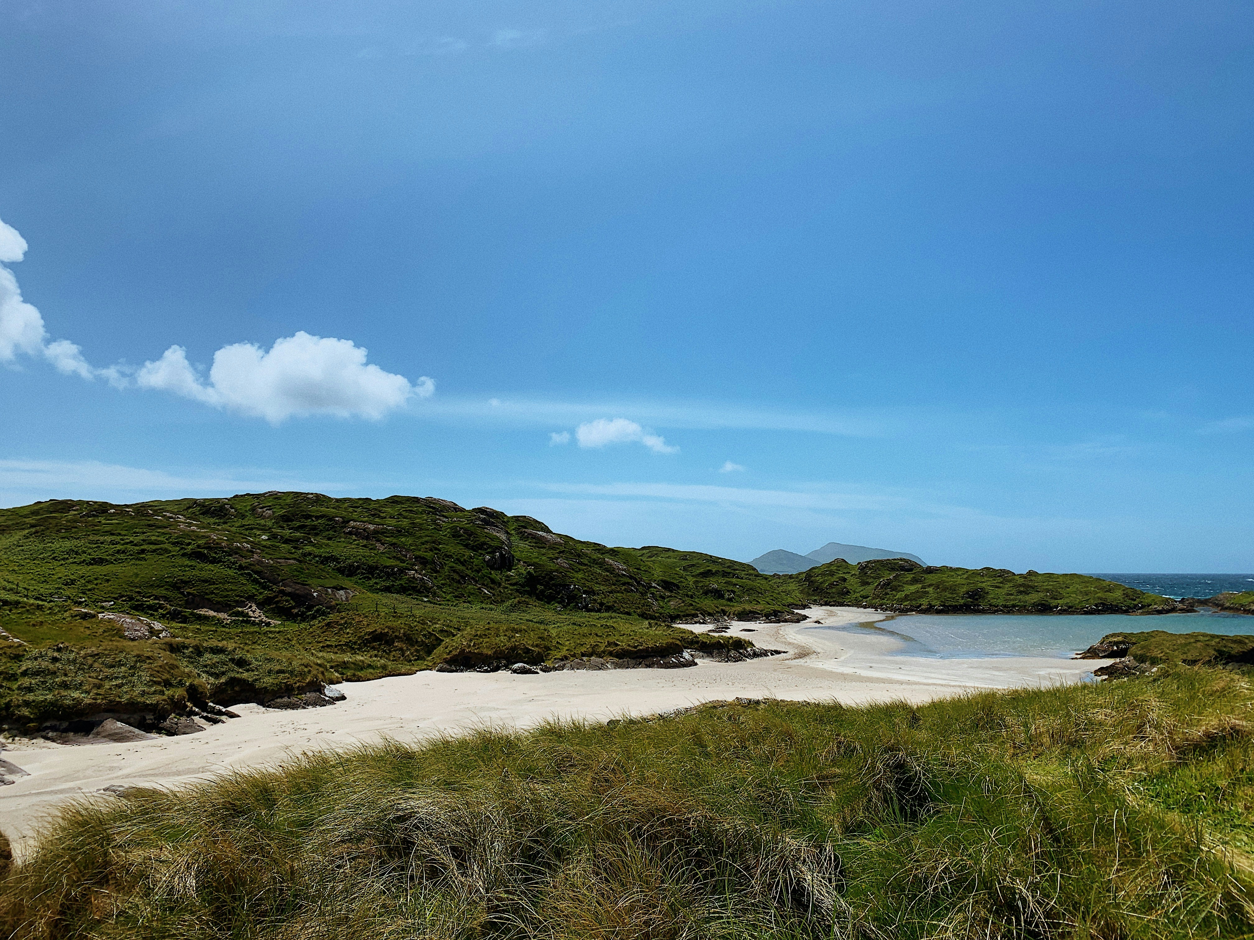 A protected, dune-backed beach with soft, white sand \u0026 the ruins of a medieval church on Abbey Island.
