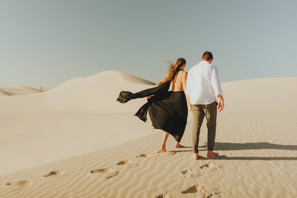 a man and woman kissing in the desert