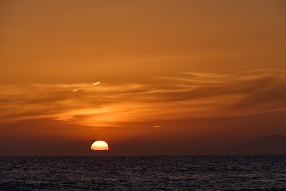 a sunset over a body of water