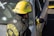 A firefighter, wearing a yellow helmet and a black fire jacket with the words 'SNOHOMISH FIRE' on the back, is standing next to a silver car. The car has yellow caution tape around its side mirror and appears to have been involved in an incident.