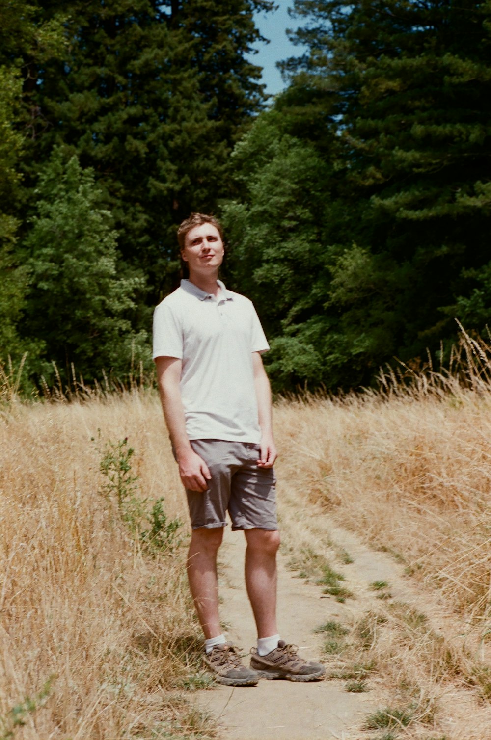 a man standing on a dirt path