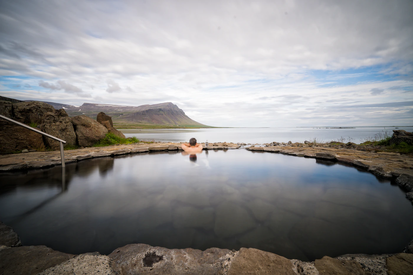Geothermal bathing pool surrounded by Icelandic landscape