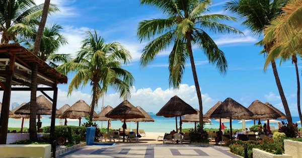 A beach with umbrellas and chairs — Cancun, Mexico