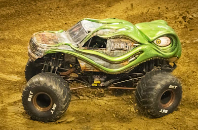 A collection of monster trucks with oversized wheels ready to crush.