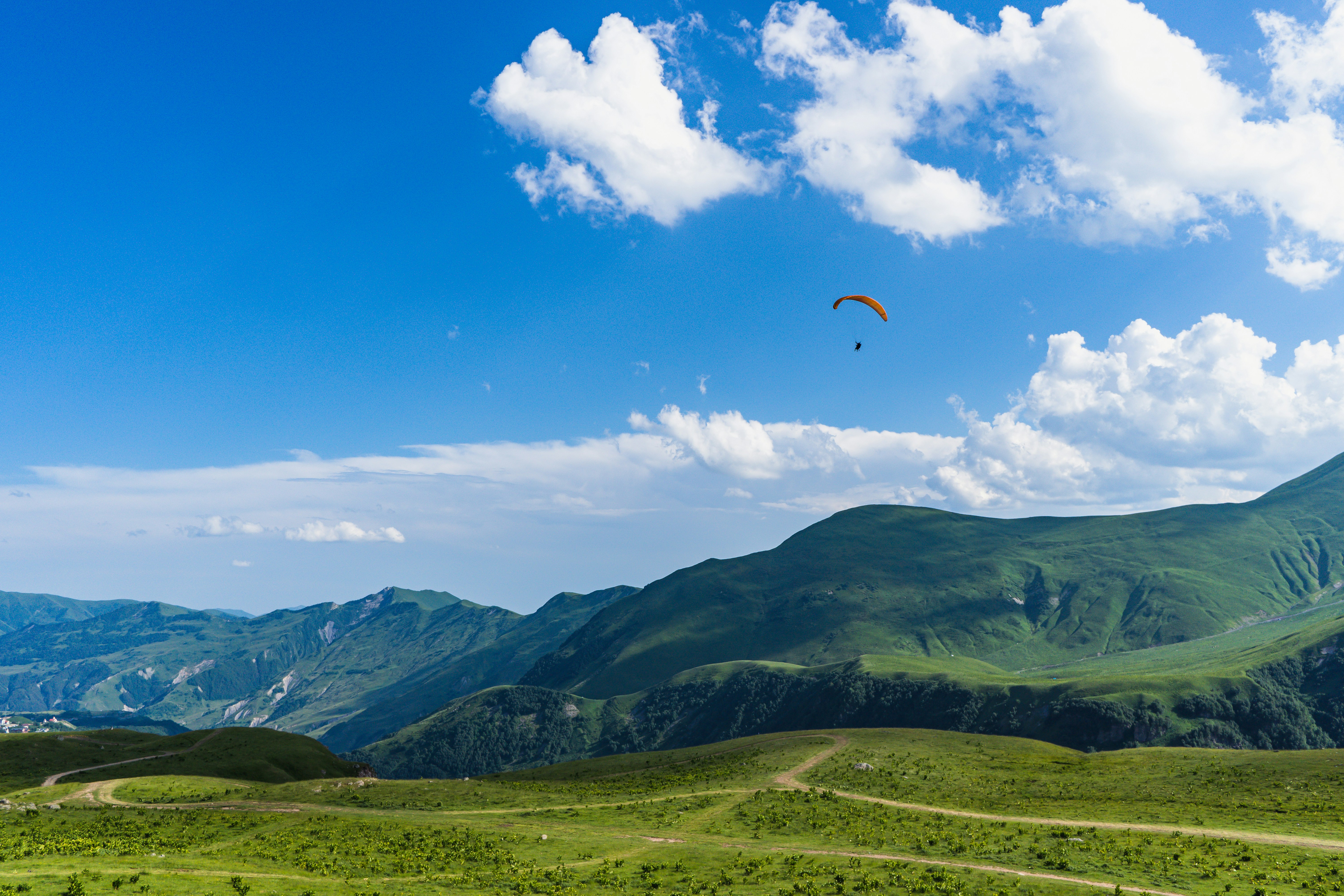 a person in the air with a parachute